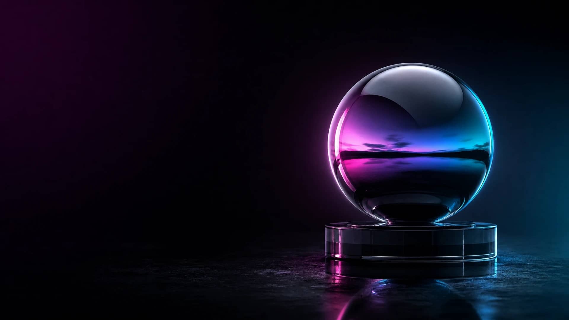 A polished chrome sphere resting on a short black glass pedestal, lit in magenta and cyan light